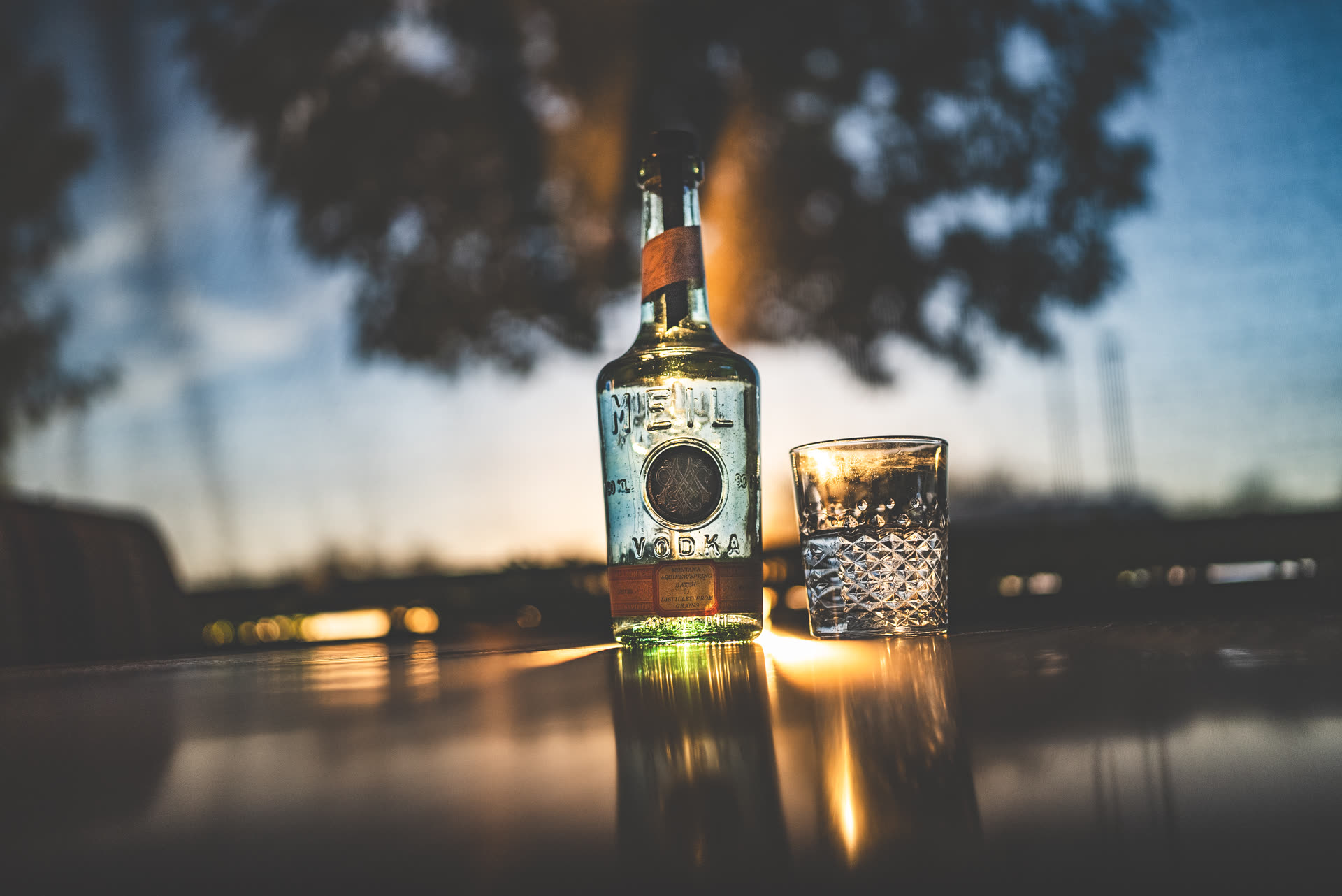 Meili bottle at a lake at dusk