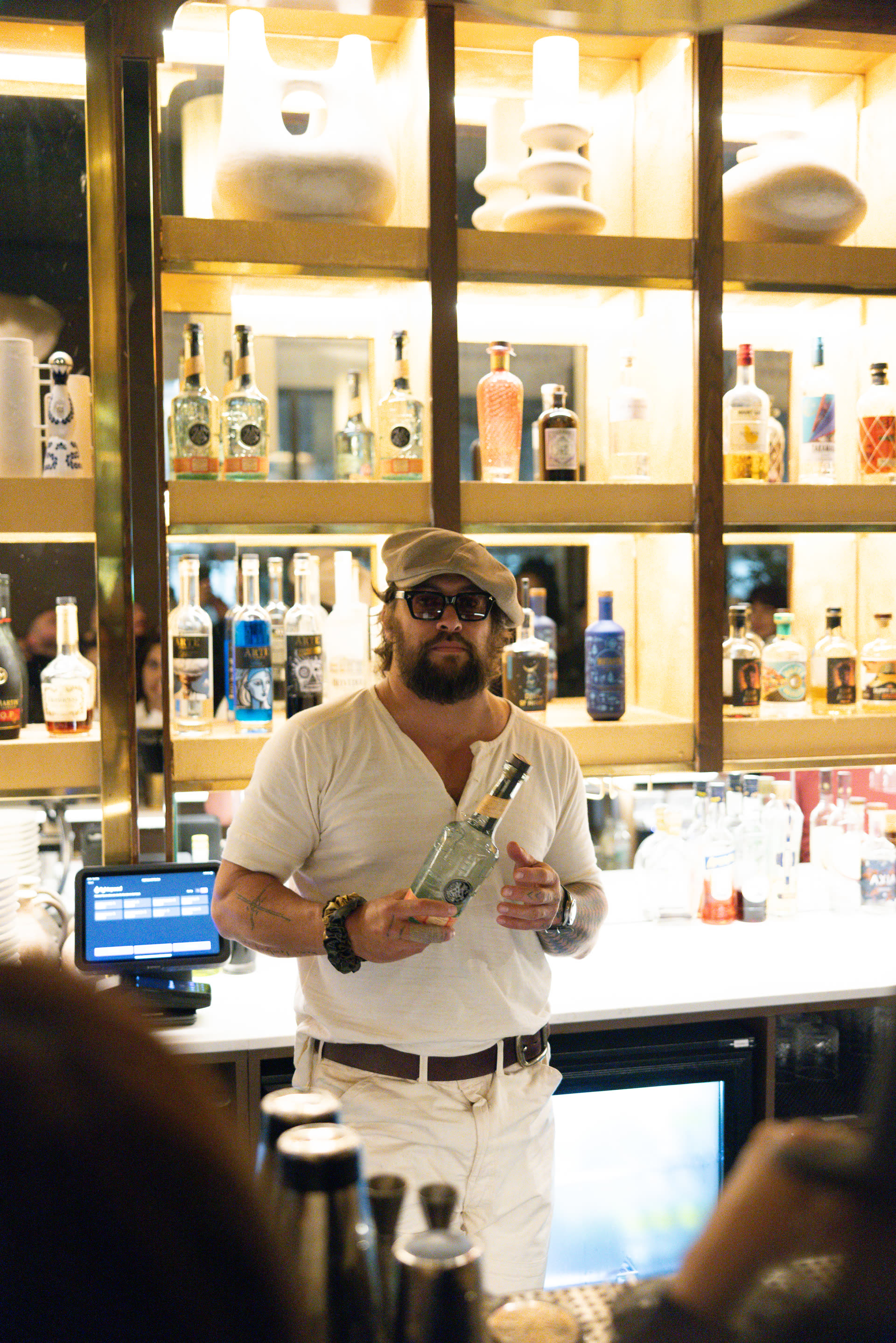 Jason Momoa behind the bar with Meili Vodka